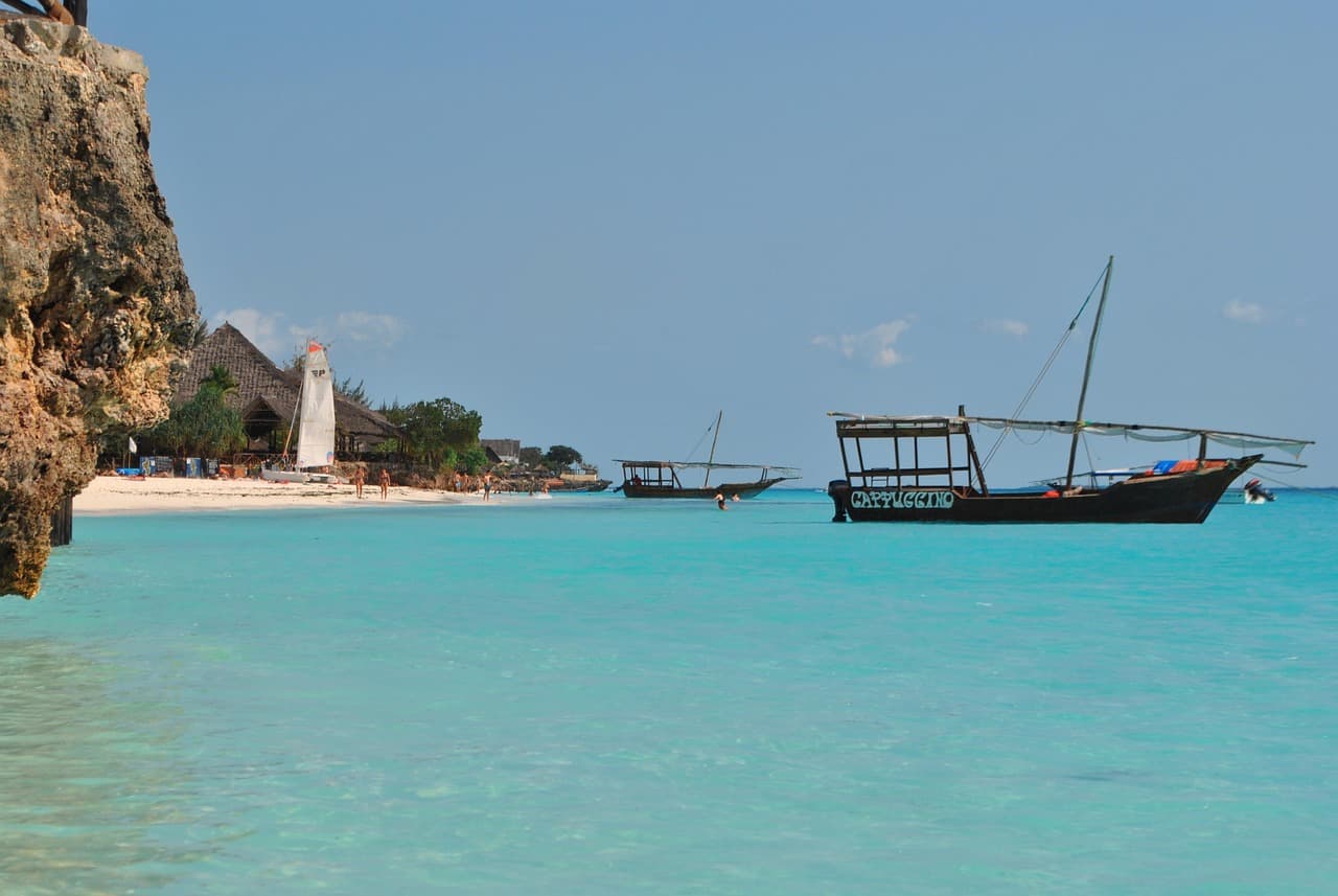 Traditional dhow boats anchored in turquoise Zanzibar waters